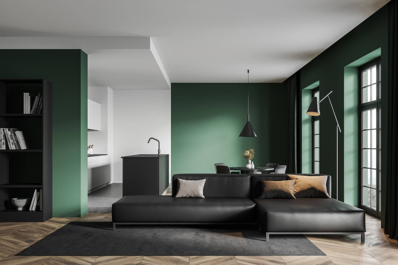 A living room with black furniture and green walls at Mr. K’s Fabric Shop near Quincy, IL